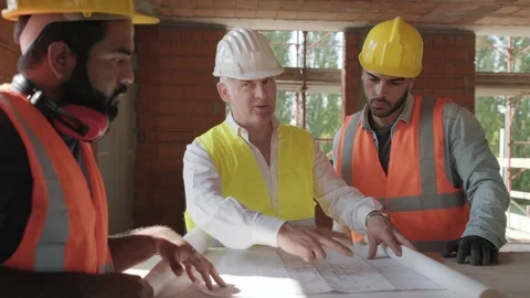 Architect Showing Building Plans To Workers In Construction Site Stock Footage 98282995