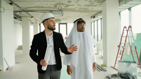 Architect showing construction plans to Arab investor in building under Stock Footage 316734537