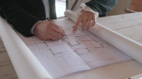 Architect Showing Project Plans To Married Couple In New Building Video stock 98800307