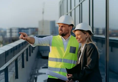 The architect shows the engineer the completed work. male and female talkin.. Stock Photos