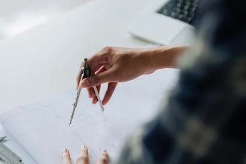 Architect sketching a construction project working on project in modern office Stock Photos