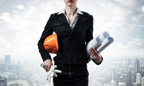 Architect standing with construction drawings Stock Photos