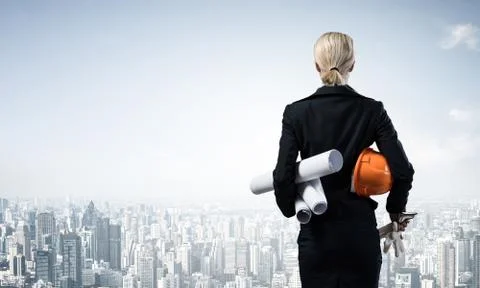 Architect standing with construction drawings Stock Photos