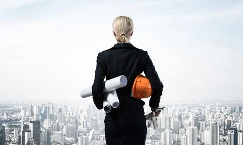 Architect standing with construction drawings Stock Photos