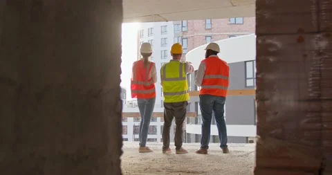 Architect standing in the construction site and look at the blueprint and tablet Stock Footage 172287308