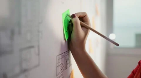 Architect Sticking Reminder Note On Blueprint Housing Project Video stock 56363281