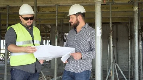 Architect talking with contruction manager about building project. Slider shot. 動画素材 70787572