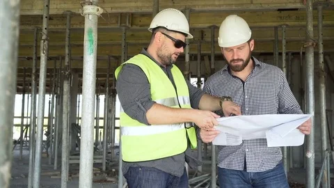 Architect talking with contruction manager about building project. Slider shot. Stock Footage 70787865