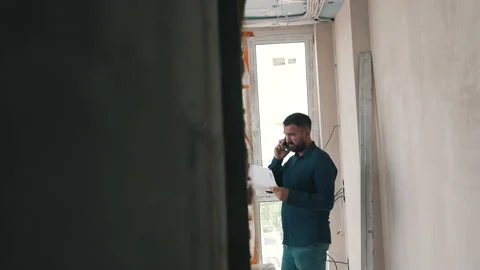 The architect is talking on the phone at the facility Stock Footage 160933081