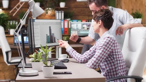 Architect talks with her colleague about new building design Stock Footage 110483884
