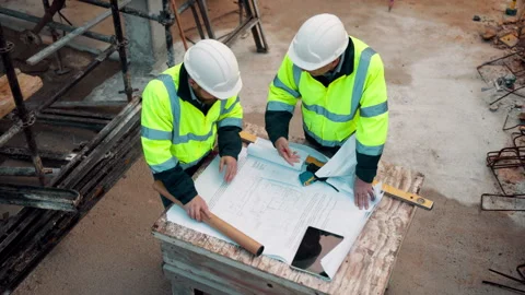 Architect, team and blueprint at construction site, planning and development Stock Footage 336189566
