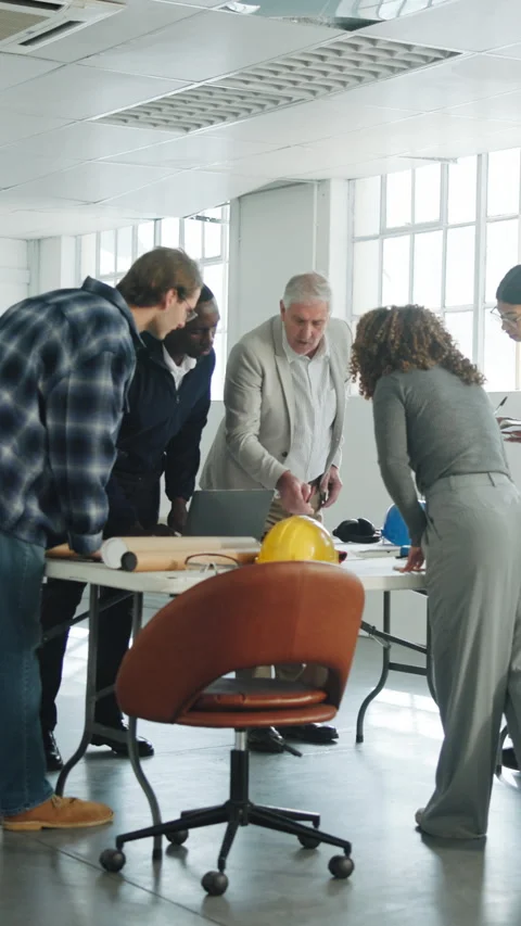 Architect, team and discussion with laptop for blueprint, construction review or Stock Footage 343839755