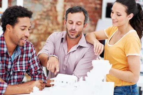 Architect, team and talking with 3D model in meeting, brainstorming and real est Stock Photos