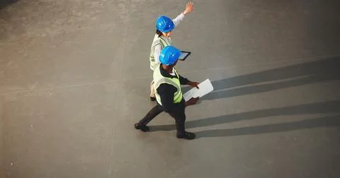 Architect, team and walking with tablet in warehouse for construction planning Stock Photos