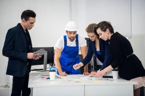 Architect team working with compasses and blueprints for architectural plan Stock Photos