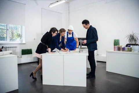 An architect team working on a project in a bright spacious office. Business Stock Photos