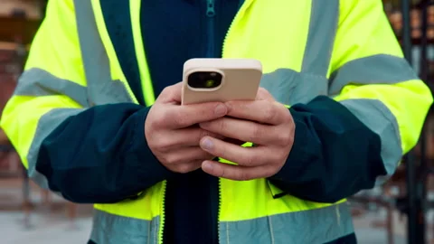 Architect, texting and hands with phone at construction site, research or Stock Footage 336189364