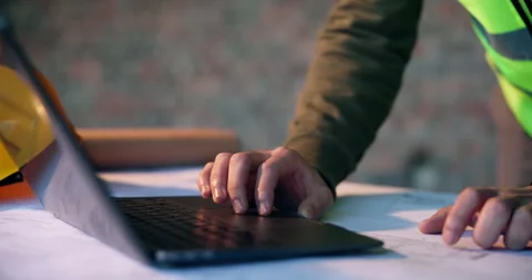 Architect, typing and hands with laptop on construction site, info and plan for Stock Footage 337038025