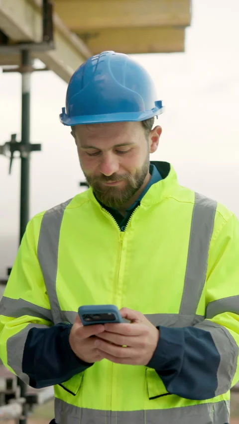 Architect, typing and man with phone on building site, online and communication Vídeos de archivo 337992036