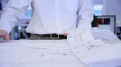 Architect unfolding a large paper plan Stock Footage 47224065