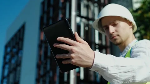 An architect uses a construction application on a digital tablet at a constructi Stock Footage 249262959