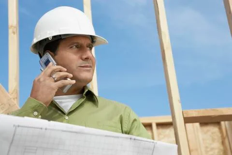 Architect Using Cellphone At Construction Site Stock Photos