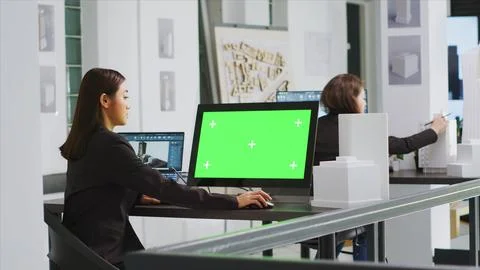 Architect using computer with greenscreen at workstation 스톡 사진