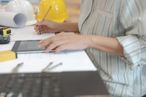 Architect using tablet. engineer working on house blueprint of real estate pr Stock Photos