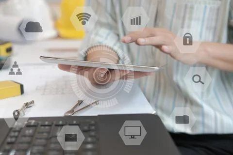 Architect using tablet. engineer working on house blueprint of real estate pr Stock Photos