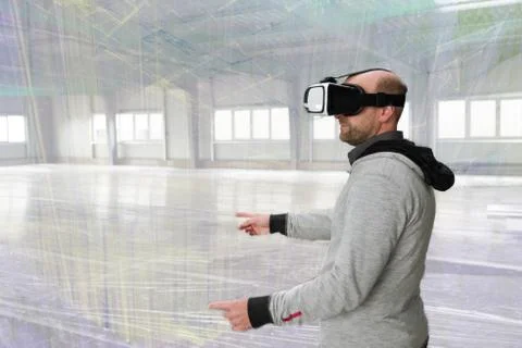 Architect with VR visor exploring industrial building environment Stock Photos