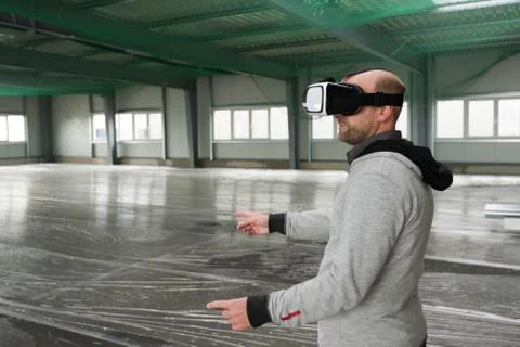 Architect with VR visor exploring industrial building environment Stock Photos