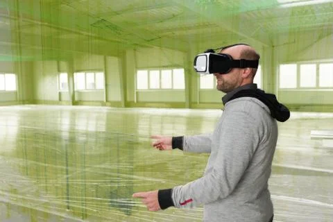 Architect with VR visor exploring industrial building environment Stock Photos