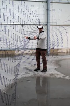 Architect with VR visor exploring industrial building environment Stock Photos