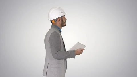 Architect walking with tablet and checking what is built on gradient background. Stock-Footage 114698749
