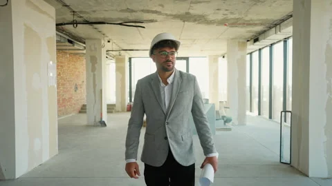 Architect walking through building under construction Stock Footage 312834824