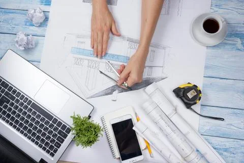 Architect working on blueprint. Architects workplace - architectural project Photos