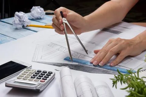 Architect working on blueprint. Architects workplace - architectural project 库存照片