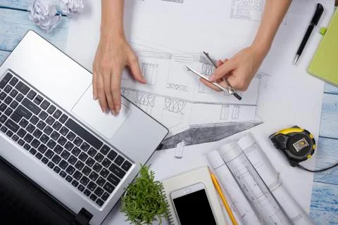 Architect working on blueprint. Architects workplace - architectural project Stock Photos