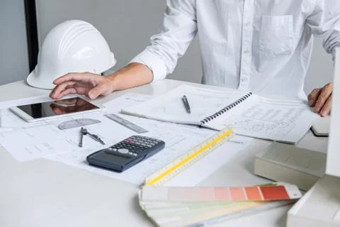 Architect working on blueprint, Engineer working with engineering tools for a Stock Photos