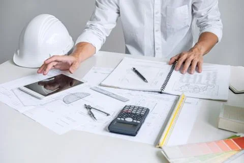 Architect working on blueprint, Engineer working with engineering tools for a Stock Photos