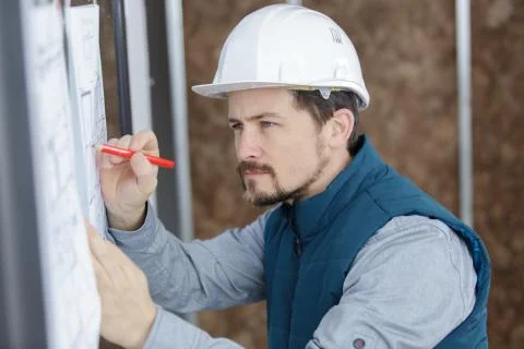 Architect working on blueprint plans Stock Photos