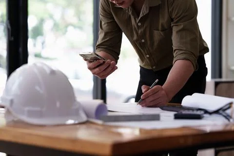 Architect working with blueprints for architectural plan, engineer sketching a Stock Photos