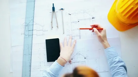 Architect working on construction blueprints Stock Footage 72584627