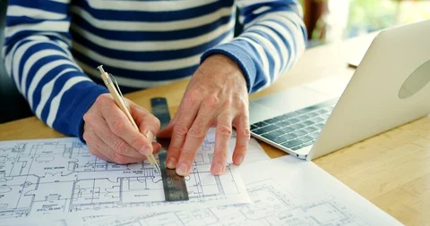 Architect Working On Construction Design Blueprints At His Desk Stock Footage 100045627
