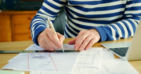 Architect Working On Construction Design Blueprints At His Desk Stock Footage 100045638