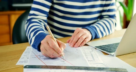 Architect Working On Construction Design Blueprints At His Desk Stock Footage 100045655