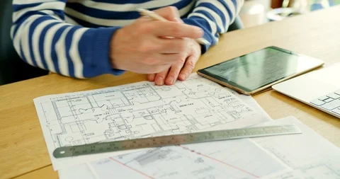 Architect Working On Construction Design Blueprints At His Desk Stock Footage 100045677