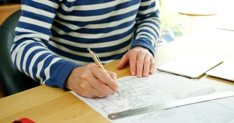 Architect Working On Construction Design Blueprints At His Desk Stock Footage 100074744