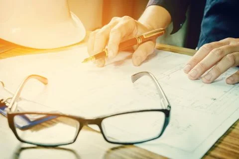 Architect working on construction engineering project blueprint Stock Photos