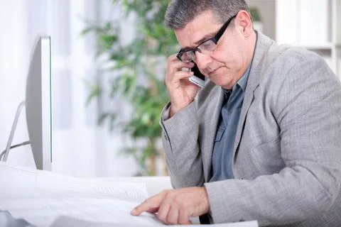 Architect working on construction plan in office Stock Photos